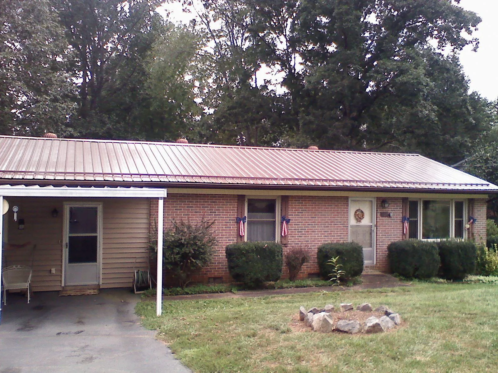 Bronze metal roof and carport on a brick ranch home in Culver
