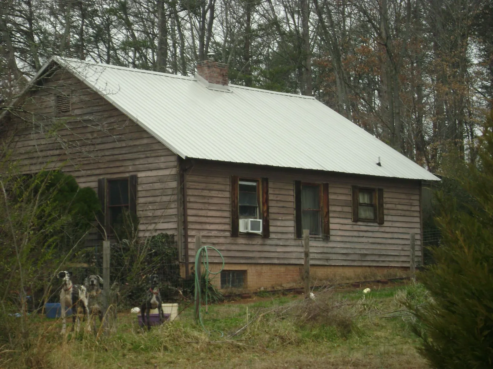 White metal roof on an old wood sided farmhouse, from a Metal Roof Installation job in Culver